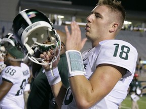 Michigan State quarterback Connor Cook (18) celebrates with teammates following a 37-24 win over Western Michigan in an NCAA college football game, Friday, Sept. 4, 2015, in Kalamazoo, Mich. (AP Photo/Al Goldis)
