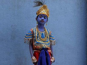 A boy dressed like Hindu Lord Krishna waits to attend celebrations on the eve of Janmashtami at a school in Mumbai, India, Friday, Sept. 4, 2015. The day marks the birth of Krishna. (AP Photo/Rajanish Kakade)
