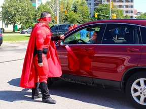 Captain Kindness (Dave Carrol) encourages locals in Brantford to be kind to their neighbours.