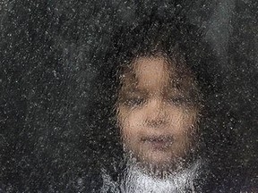 A migrant child looks out of the bus window in the village of Miratovac near the southern Serbian town of Presevo on September 10, 2015. A record 5,000 migrants have arrived at Serbia's border with Hungary over the past 24 hours, a television report said on September 10. Some 3,000 of them have already entered into Hungary, the state RTS television said. Most of the migrants are moving through Hungary on their way to Germany and other northern countries where they hope to win asylum. The EU unveiled plans to take 160,000 refugees from overstretched border states, as the United States said it would accept more Syrians to ease the pressure from the worst migration crisis since World War II. AFP PHOTO / ARMEND NIMANIARMEND NIMANI/AFP/Getty Images
