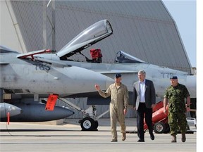 Prime Minister Stephen Harper, middle, gets a tour of Canada's CF-18's at Camp Fortin on the Trapani-Birgi Air Force Base in Trapani, Italy, on Thursday, September 1, 2011.  (Sean Kilpatrick/Canadian Press files)