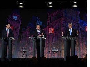 Liberal Leader Justin Trudeau, left, NDP Leader Tom Mulcair and Conservative Leader Stephen Harper take part in the leaders' debate as moderator David Walmsley looks on Thursday, September 17, 2015 in Calgary.
(Sean Kilpatrick/The Canadian Press)