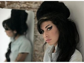 British singer Amy Winehouse poses for photographs after being interviewed by The Associated Press at a studio in north London. Social workers in Thailand think the sad story of the late musician Winehouse can be a lesson to wayward youth, so they are treating about 100 of them to a movie about her. Winehouse, bedeviled by addictions to drug and drink before her death in 2011 at the age of 27, was the subject of a well-received documentary this year, "Amy." (AP Photo/Matt Dunham, File)