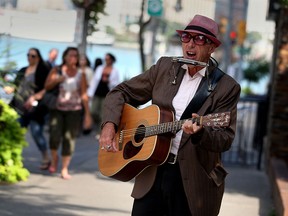 The Downtown BIA is sponsoring street entertainment in front of bars this weekend. Here street musician Raynond Cool, 64, sings in both official languages on Ouellette Avenue Tuesday September 15, 2015.