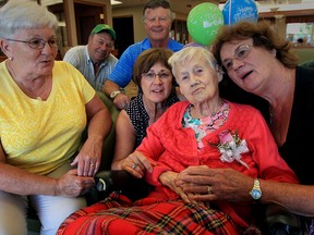 Family group hug for Adeline Jobin, centre right, who celebrated her 102rd birthday at Schlegel Villages' Village at St. Clair Sept. 16, 2015.  Judy Jobin, left, Lawrence Jobin, Art Bowen, Gay Bowen and Dona Mcfarlane, right, pose with their mother on her big day. (NICK BRANCACCIO/The Windsor Star)