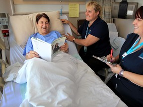 Windsor Regional Hospital Ouellette Avenue campus patient Karen Brown, left, is visited by volunteers Jamie Bessette and Anne-Marie Ferrari, right, who are part of the Welcome Mat program which helps patients get accustomed with their new surroundings. (NICK BRANCACCIO/The Windsor Star)