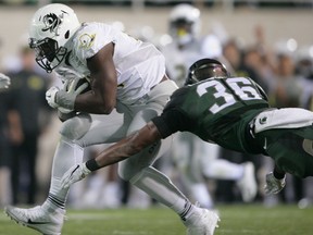 Windsor's Arjen Colquhoun, right, tackles Oregon's Royce Freeman during the first quarter of an NCAA college football game, Saturday, Sept. 12, 2015, in East Lansing, Mich. (AP Photo/Al Goldis)