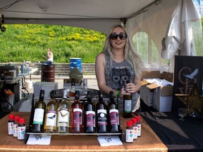 Gaebrielle Gomes of Cooper's Hawk Vineyards displays wine sample at Fork and Cork Festival in Windsor on Saturday, July 4, 2015. (JESSELYN COOK/The Windsor Star)