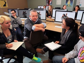 St. Clair College instructor Matthew Daley, centre, with advertising students who are working in partnership with DWBIA October 20, 2015.  In photo, students collect ideas for Pushers Collective campaign.