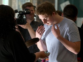 St. Clair College music theatre student Brandon Diesbourg, right, receives traditional smudge during Indigenous Education Protocol signing at St. Clair College September 22, 2015. (NICK BRANCACCIO/The Windsor Star)