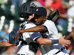 Detroit Tigers relief pitcher Neftali Feliz, right, celebrates with Detroit Tigers catcher James McCann after beating the Chicago White Sox 7-4 in a baseball game in Detroit Wednesday, Sept. 23, 2015. (AP Photo/Paul Sancya)