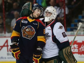 Erie Otters Jake Marchment gets a hug from Windsor Spitfires goaltender Michael Giugovaz in the Ontario Hockey League opening game at the WFCU Centre in Windsor, Ontario on September 24, 2015. (JASON KRYK/The Windsor Star)