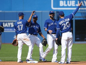 Toronto's Ryan Goins, from left, Ben Revere, Jose Bautista and Josh Donaldson celebrate after the Blue Jays defeated the Baltimore Orioles on September 5, 2015 at Rogers Centre in Toronto, Ontario, Canada. (Photo by Tom Szczerbowski/Getty Images)