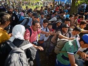 Migrants force their way through police lines at Tovarnik station in Croatia to board a train bound for Zagreb on Sept. 17, 2015. (Photo by Jeff J. Mitchell/Getty Images)