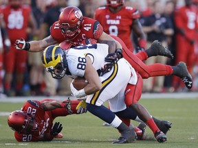 Utah linebacker Jared Norris (41) tackles Michigan tight end Jake Butt (88) in the first quarter during an NCAA college football game, Thursday, Sept. 3, 2015, in Salt Lake City. (AP Photo/Rick Bowmer)