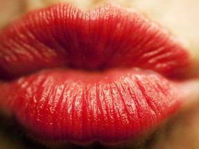 A pair of lips covered in red lipstick. (Getty Images files)