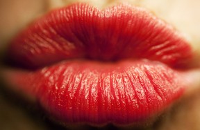 A pair of lips covered in red lipstick. (Getty Images files)