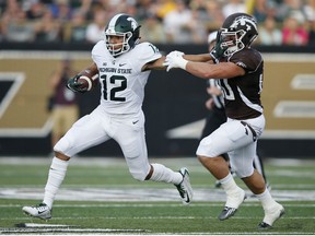 R.J. Shelton #12 of the Michigan State Spartans runs with the ball against Grant DePalma #40 of the Western Michigan Broncos in the first half at Waldo Stadium on September 4, 2015 in Kalamazoo, Michigan. (Photo by Joe Robbins/Getty Images)