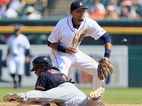 Detroit Tigers shortstop Dixon Machado, right, gets the ball too late to get the force out on Cleveland Indians' Michael Martinez (1) at second base during tyne sixth inning of a baseball game at Comerica Park Sunday, Sept. 6, 2015, in Detroit. Machado's relay to first was also to late to make the out on Cleveland's Jason Kipnis. The Indians defeated the Tigers 4-0. (AP Photo/Duane Burleson)