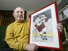 Terry McDonnell, former vice-president of hockey operations for the Carolina Hurricanes pictured in his Essex home holding an autographed pictured of Ron Francis, one of the more notable players in the team's history.(The Windsor Star-Dan Janisse)