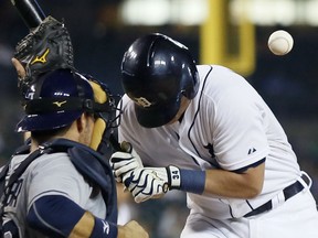 Detroit Tigers' James McCann is hit by a pitch from Tampa Bay Rays' Alex Colome as Tampa Bay catcher J.P. Arencibia, left, works behind the plate during the sixth inning of a baseball game at Comerica Park Tuesday, Sept. 8, 2015, in Detroit. (AP Photo/Duane Burleson)