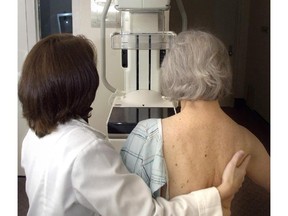 A technician prepares a woman for a digital mammogram. (Associated Press files)