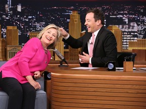 Hillary Rodham Clinton, left, invites host Jimmy Fallon to pull her hair during a taping of "The Tonight Show Starring Jimmy Fallon," on Wednesday, Sept. 16, 2015, in New York. (Douglas Gorenstein/NBC via AP)