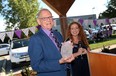 Dave Wilson is presented with an award by Hayley Morgan at Big Brothers/Big Sisters in Windsor on Friday, September 18, 2015. Wilson donated $300,000 to the organization.                                (TYLER BROWNBRIDGE/The Windsor Star)