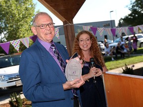 Dave Wilson is presented with an award by Hayley Morgan at Big Brothers/Big Sisters in Windsor on Friday, September 18, 2015. Wilson donated $300,000 to the organization.                                (TYLER BROWNBRIDGE/The Windsor Star)