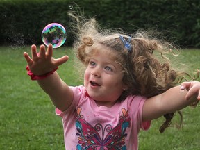 Julia Diab, 3, chases down a bubble at Windsor's first Ultimate Block Party in front of City Hall Square West, Wednesday, August 31st, 2011.  The event is sponsored by the Greater Essex County District School Board and Parenting and Family Literacy Centres.  (DAX MELMER / The Windsor Star)