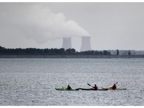 AMHERSTBURG, ONTARIO - SEPTEBMER 30, 2014 - Kayakers make their way out to Lake Erie as the Fermi 2 nuclear power plant is seen on the horizon on an overcast day on July 30, 2014 near Amherstburg, Ontario. (JASON KRYK/The Windsor Star)