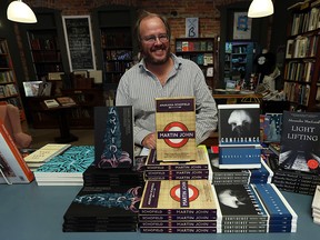Daniel Wells at Windsor publishing house and used bookstore Biblioasis with copies of the books that have been nominated for the Giller Prize. Photographed Sept. 9, 2015. (Tyler Brownbridge / The Windsor Star)