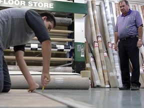 Matt Giordimaina cuts some flooring under the watchful eye of Jim Moran, co-owner with his brother Bob of The Floor Store.
- Rick Dawes: Special to The Star