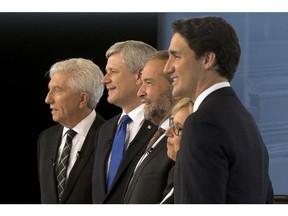 Bloc Quebecois Leader Gilles Duceppe, from left to right, Conservative Leader Stephen Harper, NDP Leader Tom Mulcair, Green party Leader Elizabeth May and Liberal Leader Justin Trudeau pose for photos before the French-language leaders' debate Thursday, September 24, 2015, in Montreal.
