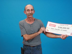 Comber's Mark Chevalier displays his cheque for $100,000 at the OLG Price Centre in Toronto. (Courtesy of OLG)