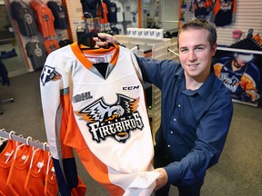 Flint Firebirds public relations representative Dominic Hennig is shown Wednesday, Sept. 9, 2015, in Flint, Mich. with some of the team's merchandise. The team is preparing for their inaugural season in the Ontario Hockey League. (DAN JANISSE/The Windsor Star)
