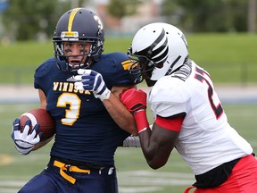Windsor's Beau Lumley (L) tangles with Carleton's Kadeem Vaillancourt during their game Saturday, Sept. 12, 2015, at the Alumni Field in Windsor, ON. (DAN JANISSE/The Windsor Star)