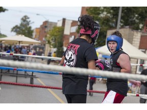 Alison Hunter, left, and Diane Meza spar in a boxing ring set up on the street by Border City Boxing during the Ford City Arts and Heritage Festival in this Sept. 26, 2015, file photo.