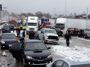 A section of multi-vehicle accident on Interstate 75 is shown in Detroit, Thursday, Jan. 31, 2013. Snow squalls and slippery roads led to a series of accidents that left at least three people dead and 20 injured on a mile-long stretch of southbound I-75. More than two dozen vehicles, including tractor-trailers, were involved in the pileups. (AP Photo/Paul Sancya)