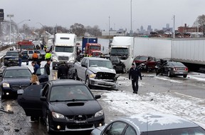 A section of multi-vehicle accident on Interstate 75 is shown in Detroit, Thursday, Jan. 31, 2013. Snow squalls and slippery roads led to a series of accidents that left at least three people dead and 20 injured on a mile-long stretch of southbound I-75. More than two dozen vehicles, including tractor-trailers, were involved in the pileups. (AP Photo/Paul Sancya)