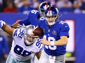 Windsor’s Tyrone Crawford, left, of the Dallas Cowboys sacks New York Giants QB Eli Manning at MetLife Stadium on November 23, 2014 in East Rutherford, New Jersey. (Photo by Al Bello/Getty Images)