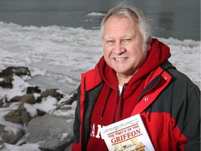 Cris Kohl, co-author of The Wreck of the Griffon with his Joan Forsberg, is pictured with his book on the banks of the Detroit River Sunday, Jan. 11, 2014, where the ship sailed in August 1679.