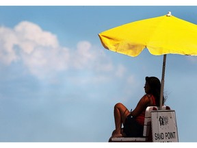 A lifeguard keeps an eye on swimmers on a hot summer day on  July 28, 2015, at the Sandpoint Beach in Windsor.