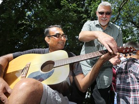 A How-To Festival was held on Saturday, Sept. 12, 2015 at the Budimir Branch of Windsor Public Library in Windsor, ON. The event featured an assortment of different how-to booths. Paresh Jariwala (L) gets a quick guitar lesson from Bob Soulliere from the South Windsor School of Music during the event.  (DAN JANISSE/The Windsor Star)