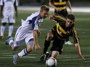 The University of Windsor Lancers Kyle Ruggaber and the Waterloo Warriors Matthew Cimino chase down the ball at Alumni Field in Windsor on Friday, September 11, 2015. The Lancers won 6-0. (TYLER BROWNBRIDGE/The Windsor Star)