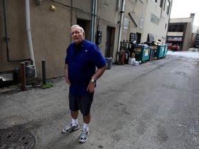 Building manager Francis Fortin inspects the alley beside the Royal Windsor Terrace condo apartment following an early morning shooting Sept. 28, 2015. Fortin released video to Windsor police hoping to apprehend the gunman.