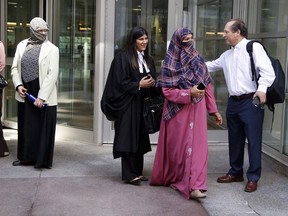 Zunera Ishaq, second from right, leaves the Federal Court of Appeal after her case was heard on whether she can wear a niqab while taking her citizenship oath, in Ottawa on Tuesday, September 15, 2015. THE CANADIAN PRESS/ Patrick Doyle