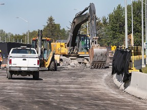 A crew rips up a recently paved section of asphalt on Highway 3 near St. Clair College in order to replace waterproofing that wasn't installed according to specifications.  (DAN JANISSE/The Windsor Star)
