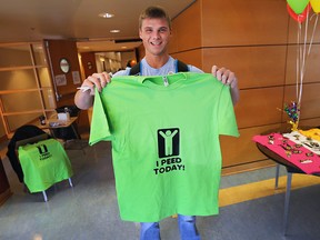 University of Windsor student Scott Hotz poses with the t-shirt he received after participating in the Ts 4 Pee event at the school on Monday, Sept. 21, 2015. Organizers were attempting to break a national record for the most number of people tested for a sexually transmitted infection at one location in 24 hours. (DAN JANISSE/The Windsor Star)