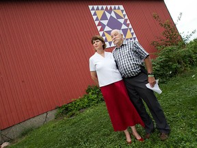 Essex mayor, Ron McDermott, stands with Janet Cobban, left, at her rural home in Essex, Saturday, Sept. 5, 2015.  Cobban provided a royal- themed barn quilt, thought to be the only one in North America, to celebrate the reign of Queen Elizabeth II.  On Sept. 9, 2015, she will be the longest serving monarch.   (DAX MELMER/The Windsor Star)